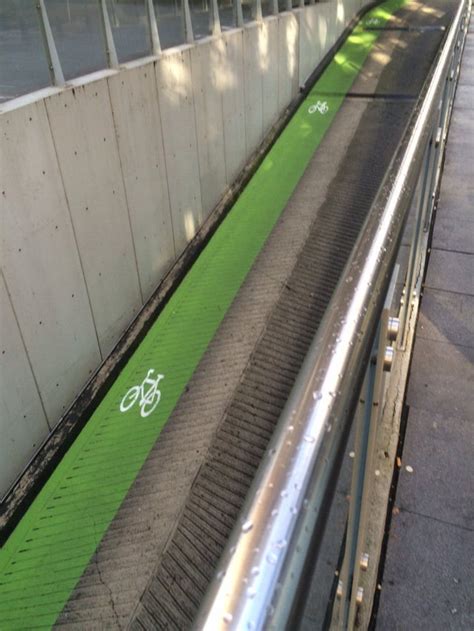 A marked bike lane along a parking garage ramp. : townhall