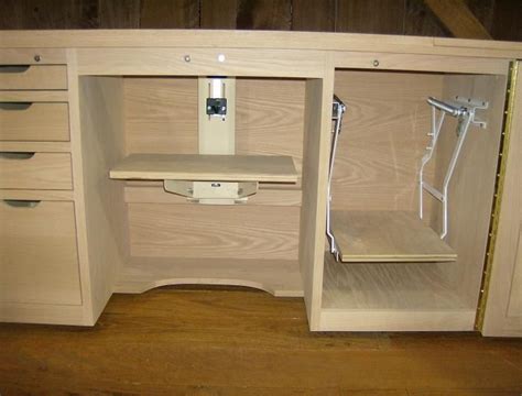 an open cabinet with shelves and drawers on the bottom, in a wood floored room