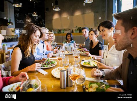 Group of friends on dinner party in restaurant Stock Photo - Alamy