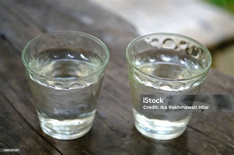 Air Putih Mineral Water In Clear Glasses Cup On A Rustic Wooden Table ...