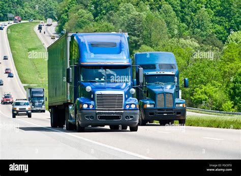 Two Blue Semi Trucks Climb Hill On Interstate Highway in Tennessee Stock Photo - Alamy