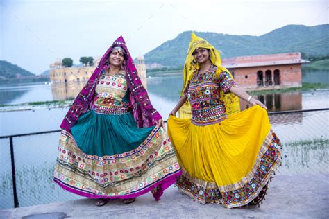 Women in traditional clothes in front Jal Mahal Palace, Jaipur, India ...