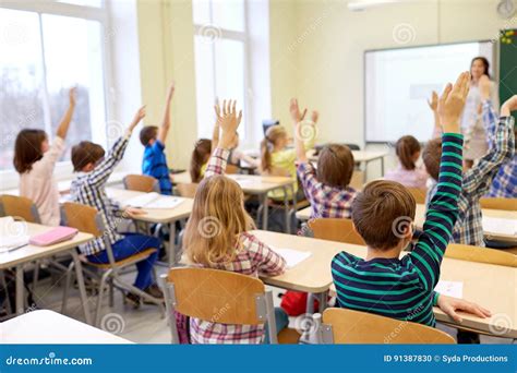 Group of School Kids Raising Hands in Classroom Stock Photo - Image of happy, schoolgirl: 91387830