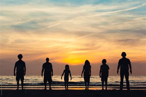 "Silhouettes Of Group Of People On The Beach At Sunset" by Stocksy ...