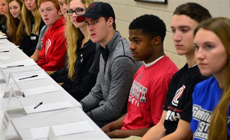 Twenty Eden Prairie athletes in different sports sign together