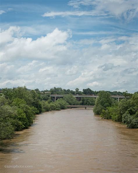 A swollen French Broad River taken from the Haywood Road Bridge in Asheville, North Carolina. # ...