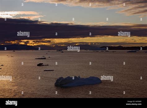 Icebergs on a very calm sea with sunset sky in Disko Bay in the Davis ...