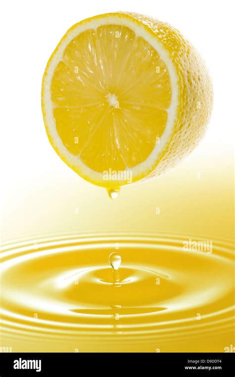 Half lemon and juice Stock Photo - Alamy