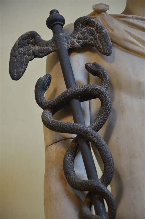 a statue with an anchor and two snakes on it