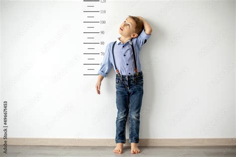 Little child, boy, measuring height against wall in room Stock Photo ...