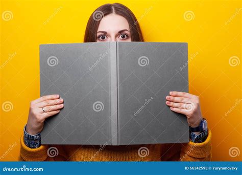 Girl Covers Her Face with a Book Stock Image - Image of fright, eyes: 66342593