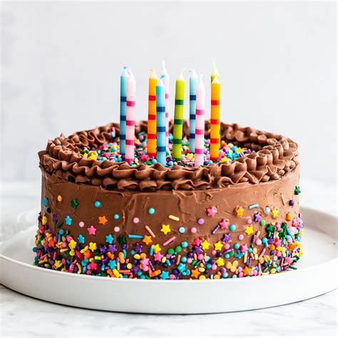 This recipe for the Best Birthday Cake with moist and fluffy yellow cake paired with rich and ...