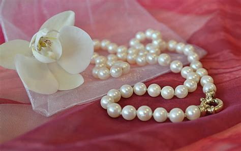 Royalty-Free photo: Silver-colored rings and white pearl necklace | PickPik