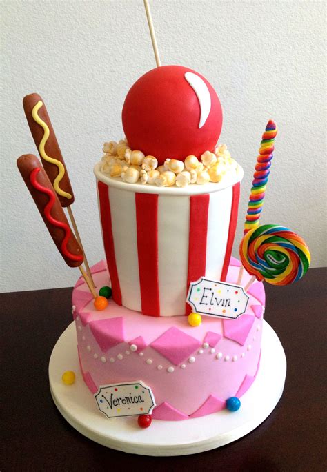 a birthday cake made to look like a popcorn bucket with candy and lollipops on top