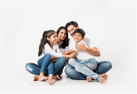 Premium Photo | Young Indian asian family sitting isolated over white ...