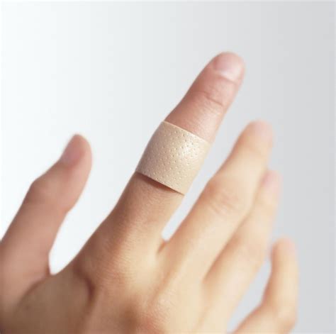 Sticking Plaster On A Finger Photograph by Cristina Pedrazzini - Fine Art America