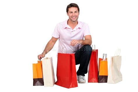 Man carrying shopping bags stock photo. Image of kneeling - 23102170