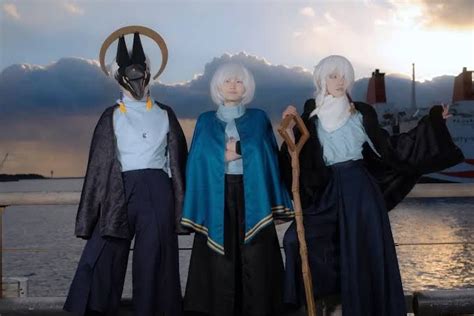 three people dressed in costumes standing next to each other on a pier near the ocean