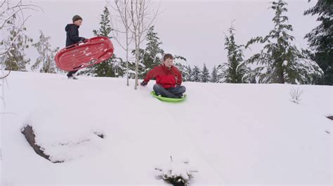 Boy Sledding Down Snow Covered Hill In Winter Stock Footage SBV ...