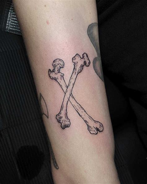 Crossed bones tattoo on the arm | Bone tattoos, Tattoos, Cool arm tattoos