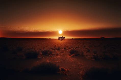 A sunset over a desert landscape