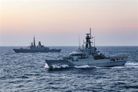 Royal Saudi Naval Force frigate Makkah (814), back, and Royal Bahrain Naval Force patrol warship ...