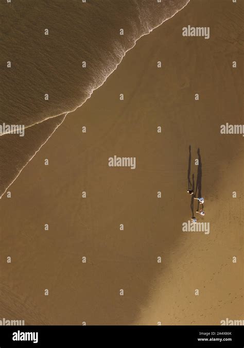 Aerial view of people walking at the beach Stock Photo - Alamy