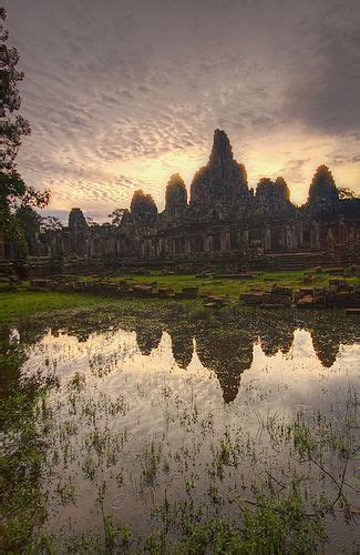 Sunrise at Bayon Temple Morning light is reflected in rainwater at Bayon Temple in Angkor Thom ...