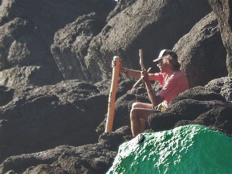 Man in Pink T-shirt with Didgeridoo Near Green Rock | Flickr