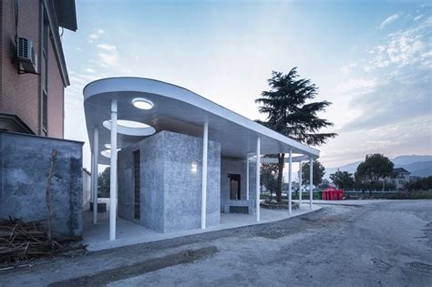 shulin architectural design unites individual blocks under curved roof for public toilet in china