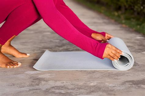 Premium Photo | Cropped of black woman unrolling fitness mat before yoga practice