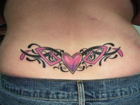 a woman's stomach with tattoos on it and a pink heart in the center