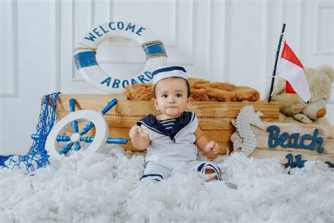 The Baby Boy Was Wearing a White and Blue Sailor Outfit. Stock Image - Image of beach, infant ...