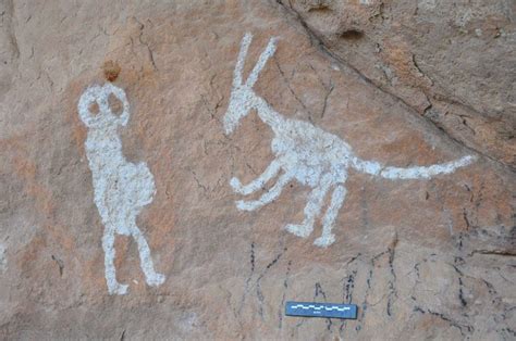 Dedza, Malawi. Close-up of figure, dog and person, possibly woman, with ...