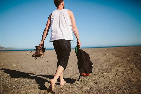 «A Man Walks Along Beach» del colaborador de Stocksy «HOWL» - Stocksy