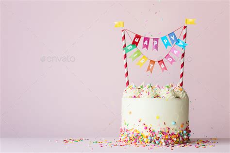 Birthday cake with colorful happy birthday banner Stock Photo by RuthBlack