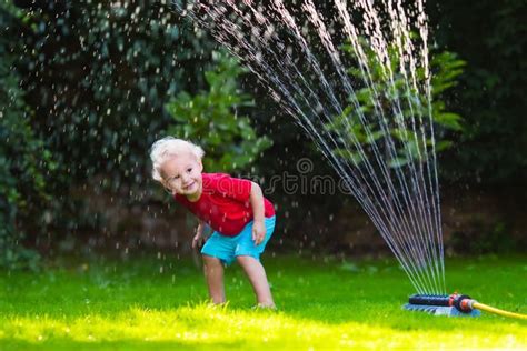 Kids Playing with Garden Sprinkler Stock Image - Image of happiness ...