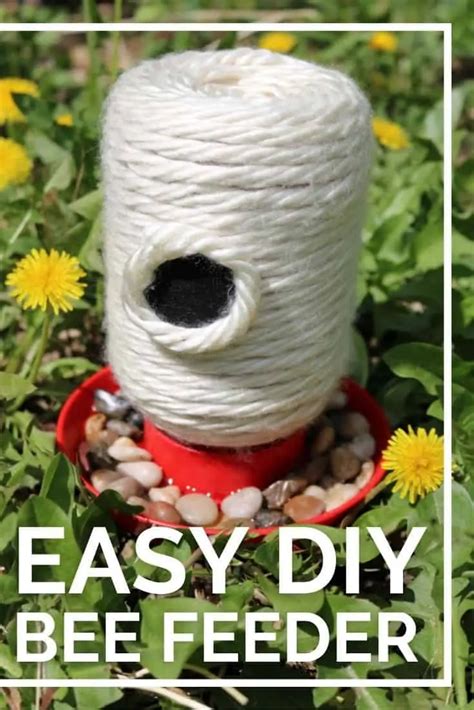 a spool of white yarn sitting on top of a red bowl filled with rocks