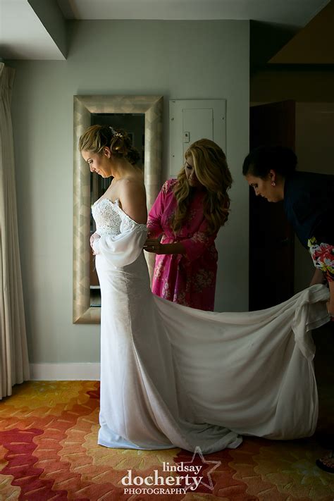 Philadelphia wedding photography at Morris House Hotel bride putting on ...