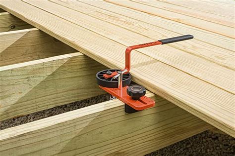 a hand held tool is attached to the side of a wooden bench