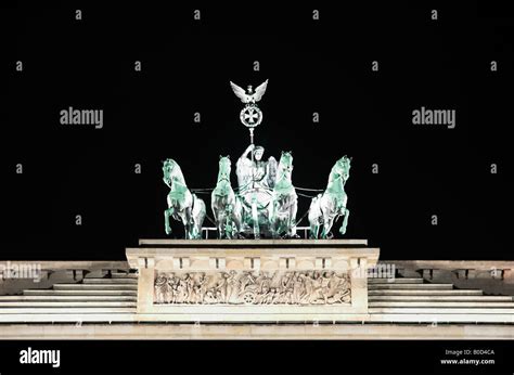 Illuminated Quadriga statue Brandenburg Gate at night low angle view ...