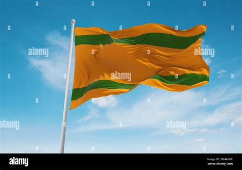 official flag of Naranjito, Puerto Rico untied states of America at cloudy sky background on ...