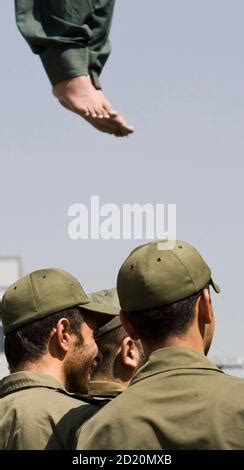 Majid Kavousifar hangs from a rope attached to a crane in Tehran August 2, 2007. Iran hanged ...