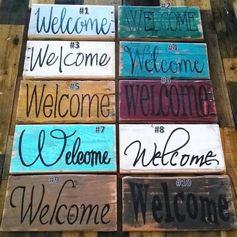 several wooden signs that say welcome, welcome, welcome and welcome on wood planks