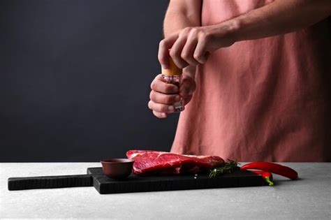 Premium Photo | Man cooking meat steak on kitchen