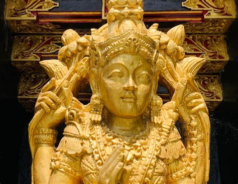 Premium Photo | Balinese hindu god golden shiva durga statue on a ...