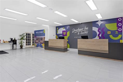 Lobby with front desk and computers with colorful signage