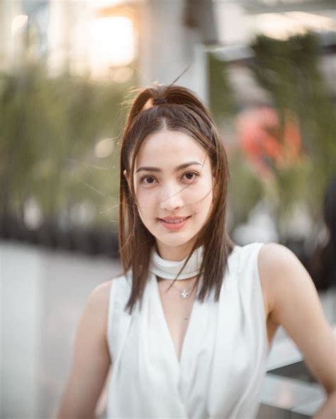 a woman in white dress posing for the camera