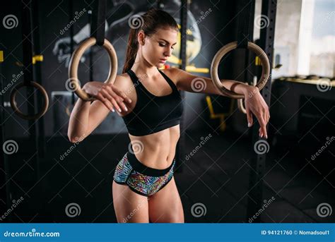 Slim Female Athlete Exercise on Gymnastic Rings Stock Photo - Image of ...