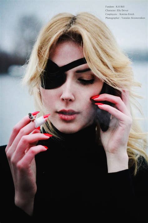 a woman holding a cell phone to her ear and wearing blindfolds while ...